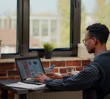 Financial consultant using laptop to work on business growth, analyzing sales management for experience. Male secretary planning innovation and development with commercial data.